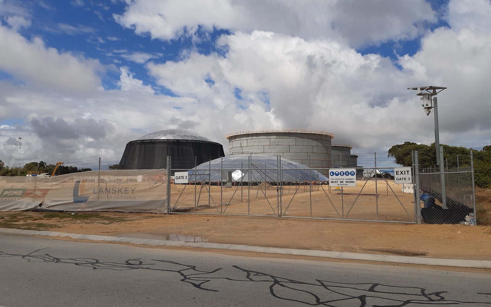 Eleven newly erected fuel storage tanks in an open compound during depot construction